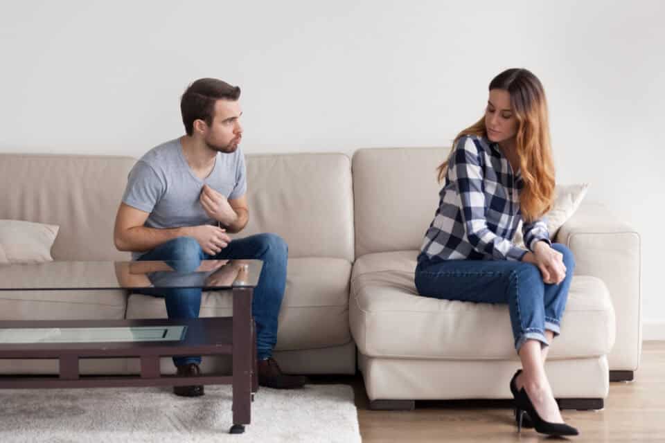 Couple on the couch having an argument.