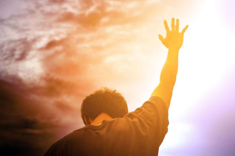Man with his arms stretched to the sky.