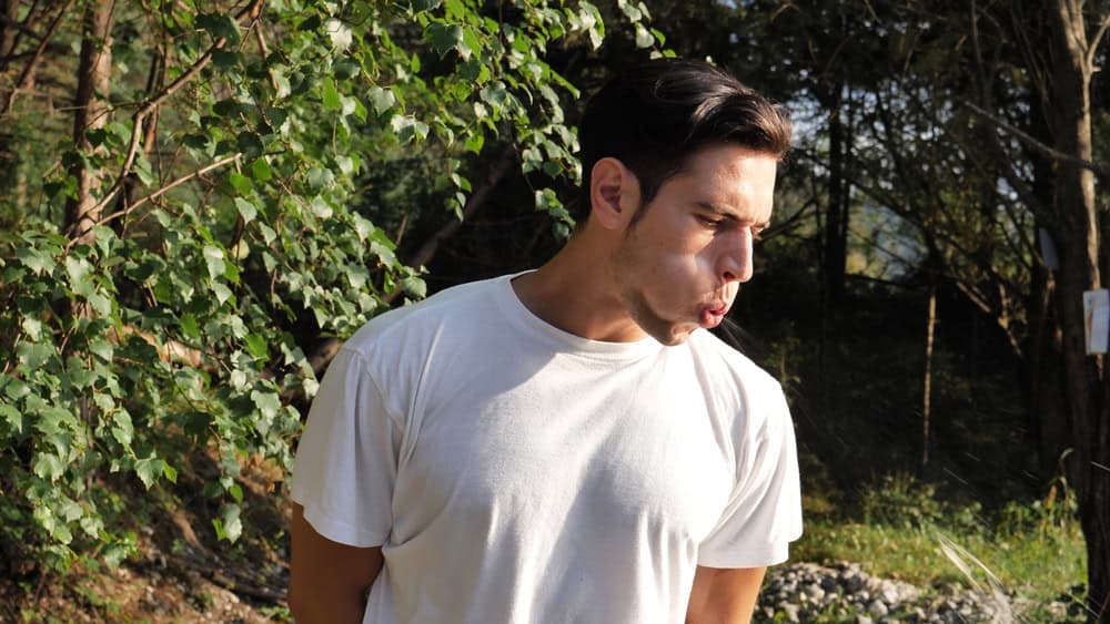 Man spitting on the ground.