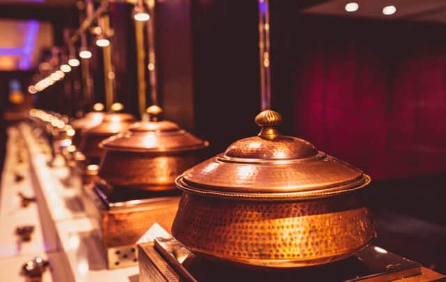 Copper pots on a buffet.