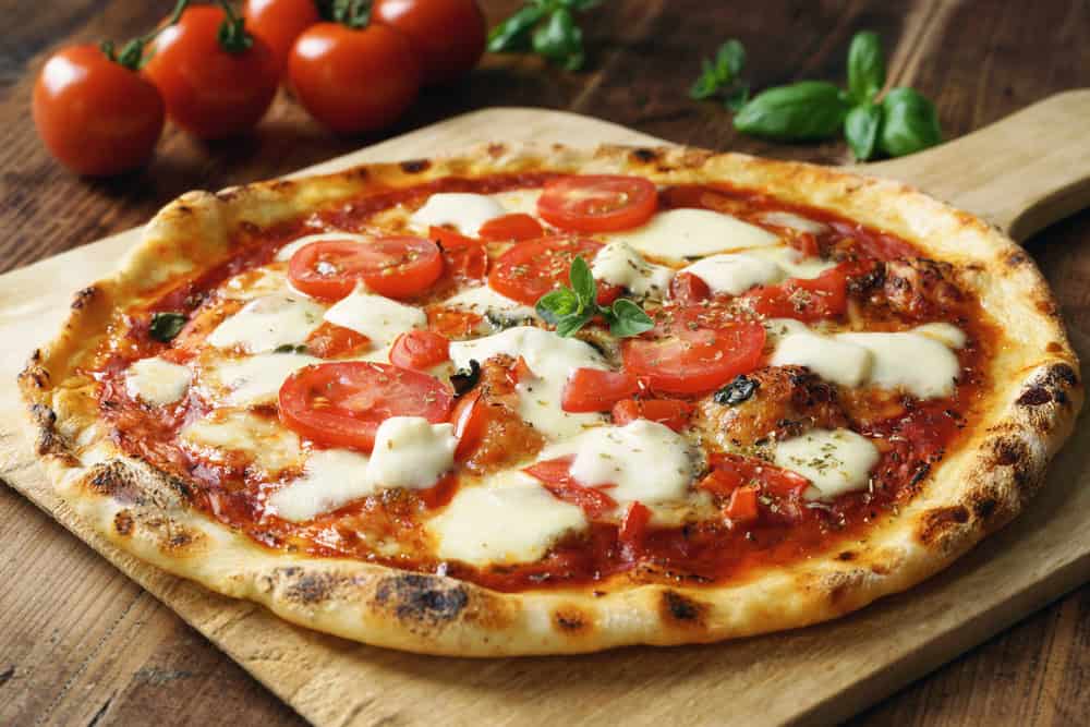Fresh pizza with tomato.