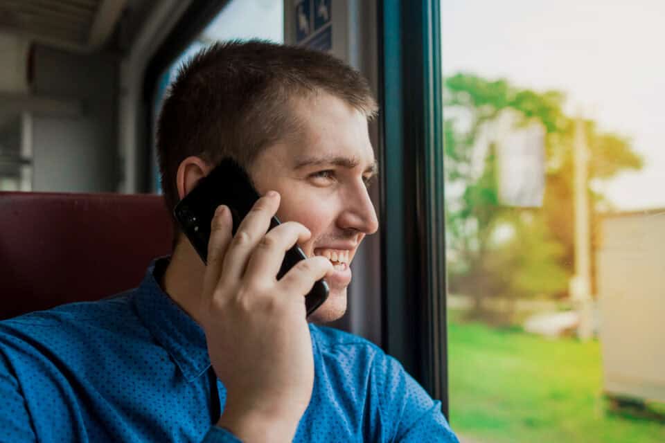 Young man laughing on the phone.