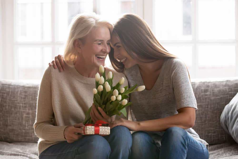 Young woman with her mom on the couch.