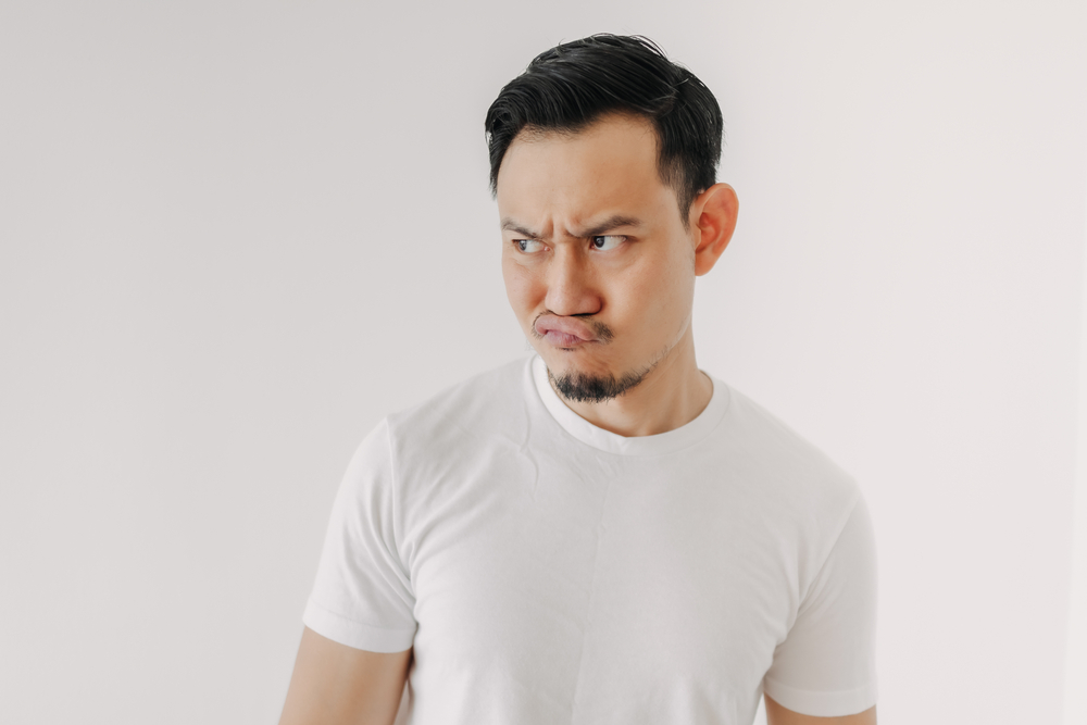 A man with a grumpy face on.
