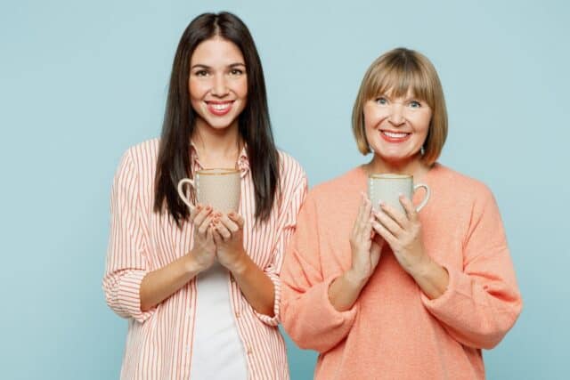 Mother and daughter having coffee.