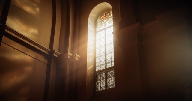 Sun rays streaming through stained glass window.