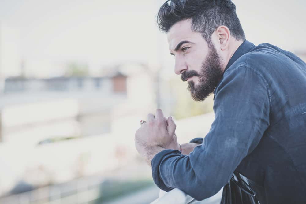 Man looking out the window deep in thought. 