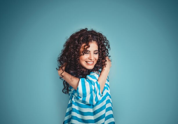 Happy woman hugging herself.