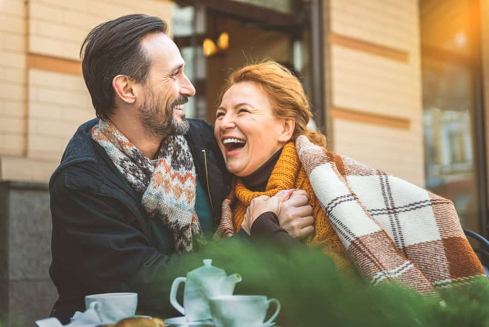 Man and woman on a date in cafe, laughing.