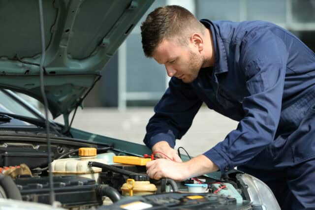 Mechanic working on a car.