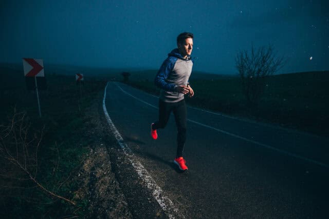Man running outside at night.