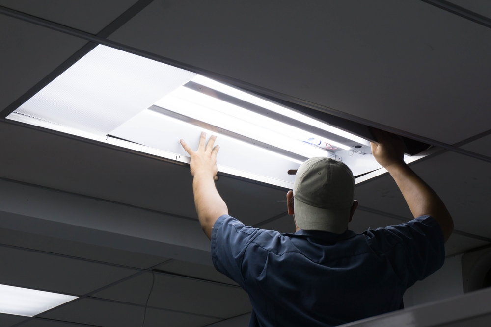 Man replacing a fluorescent bulb.