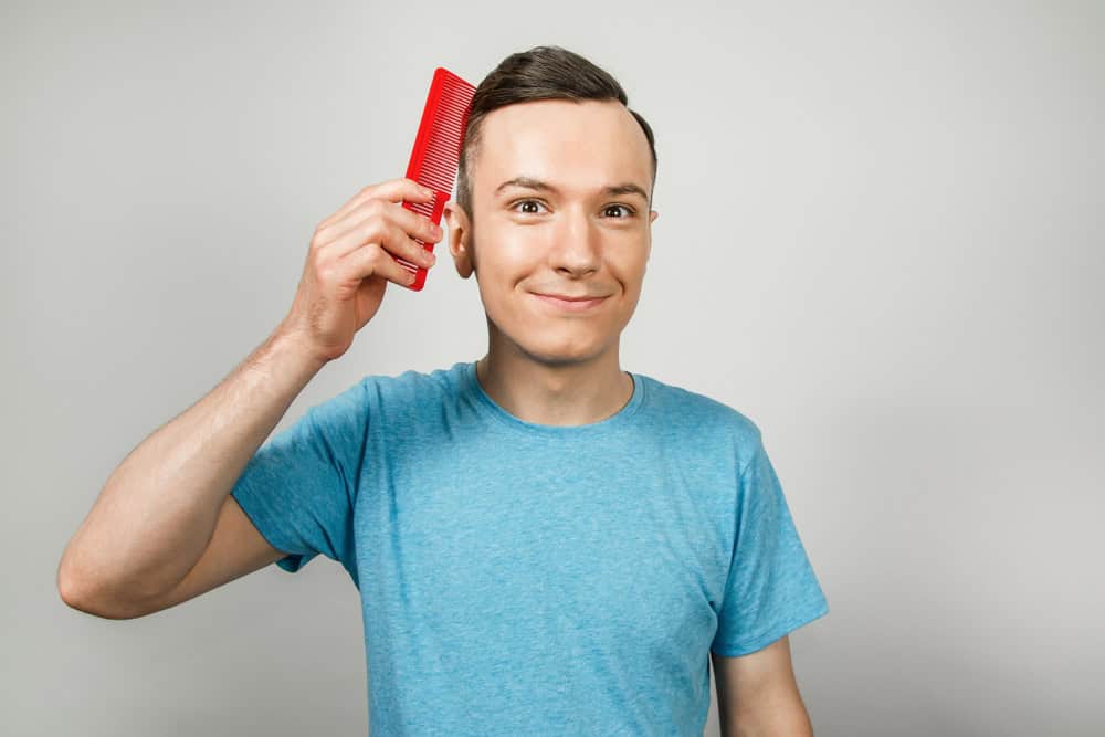 Man combing his hair.