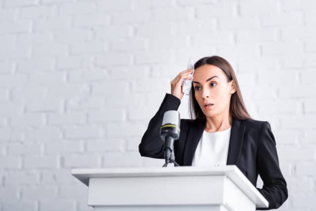 Woman stressed after giving a presentation.