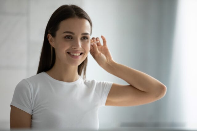Woman cleaning her ears.