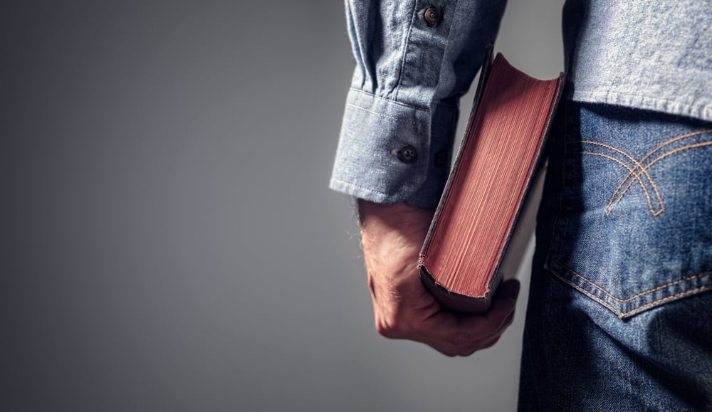 Man holding a holy book.