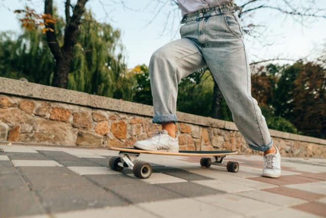 Woman skateboarding in sweatpants.