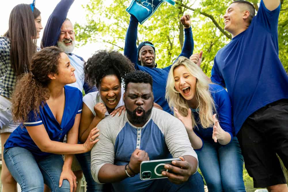 A group of friends cheering on a win.