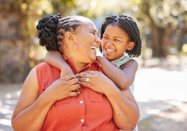 Grandmother laughing with her granddaughter.