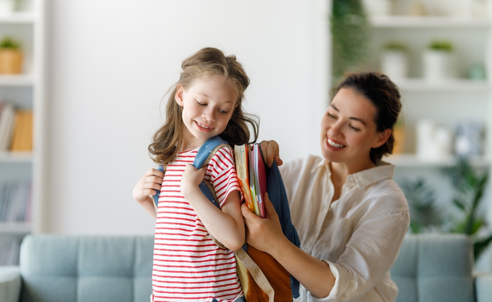 Mom getting her daughter off to school/