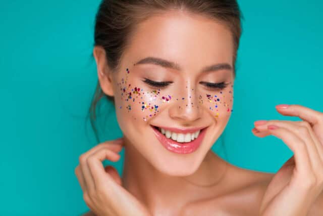 Woman wearing festive makeup.