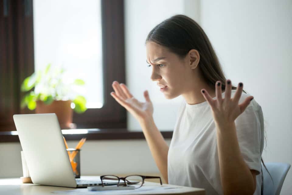 Woman looking confused at her computer.