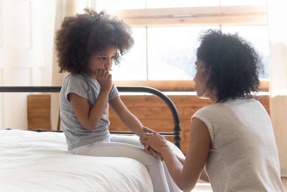 Mother comforting her scared upset child.