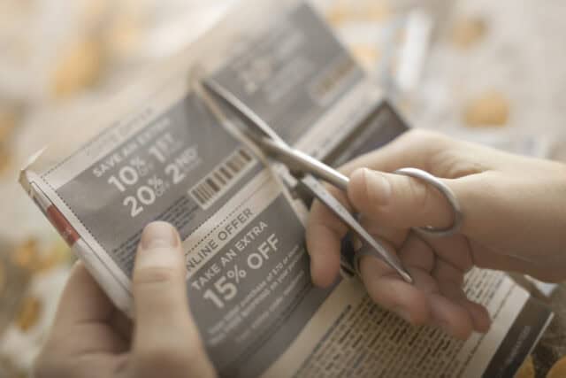 Woman clipping coupons.