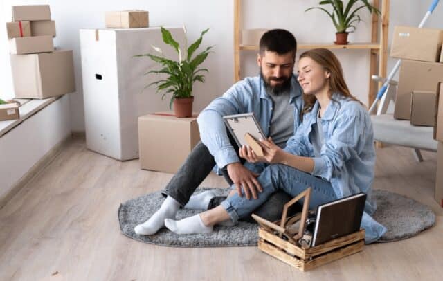 Happy,Young,Couple,Sit,On,Floor,In,Casual,Clothes,Hugging