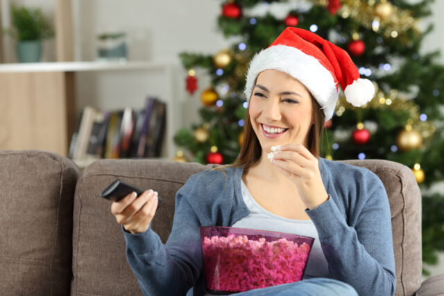 Woman watching TV at Christmas.