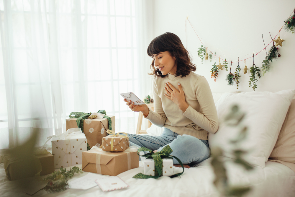 Woman reading Christmas cards.
