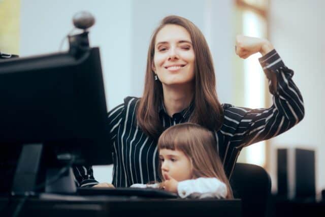 Strong,Mom,Flexing,Her,Muscles,While,Multitasking,At,Work,Mother
