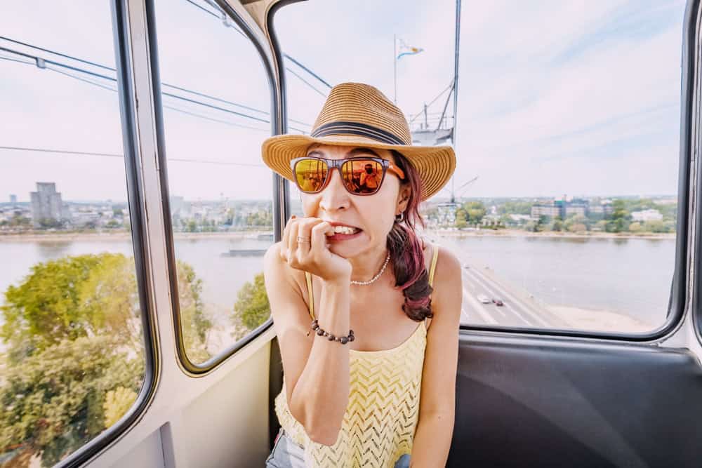 Woman sitting on a tram feeling unsure. 