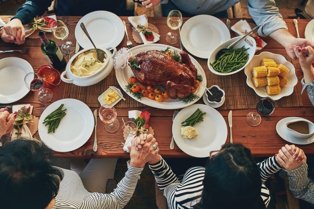 A family meal with a table full of food.