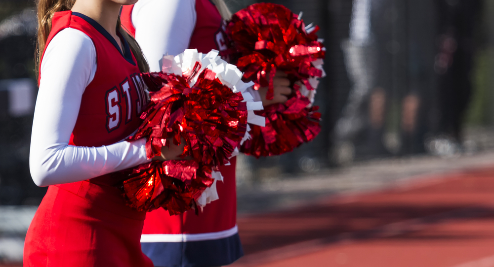 Cheerleaders Holding Pom Poms.