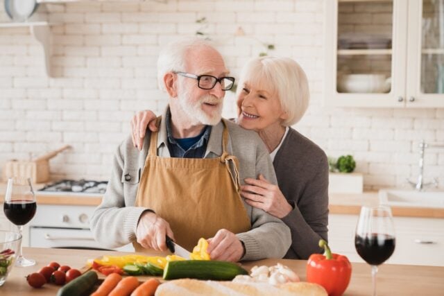 Older couple cooking together.