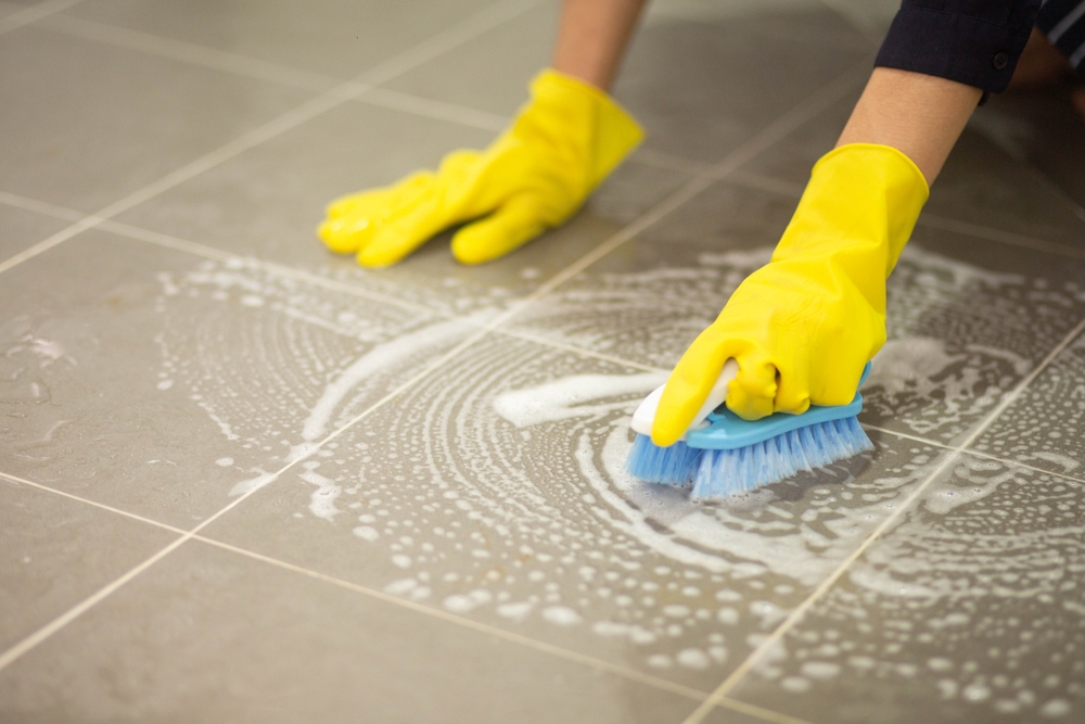 Woman cleaning while wearing rubber gloves.