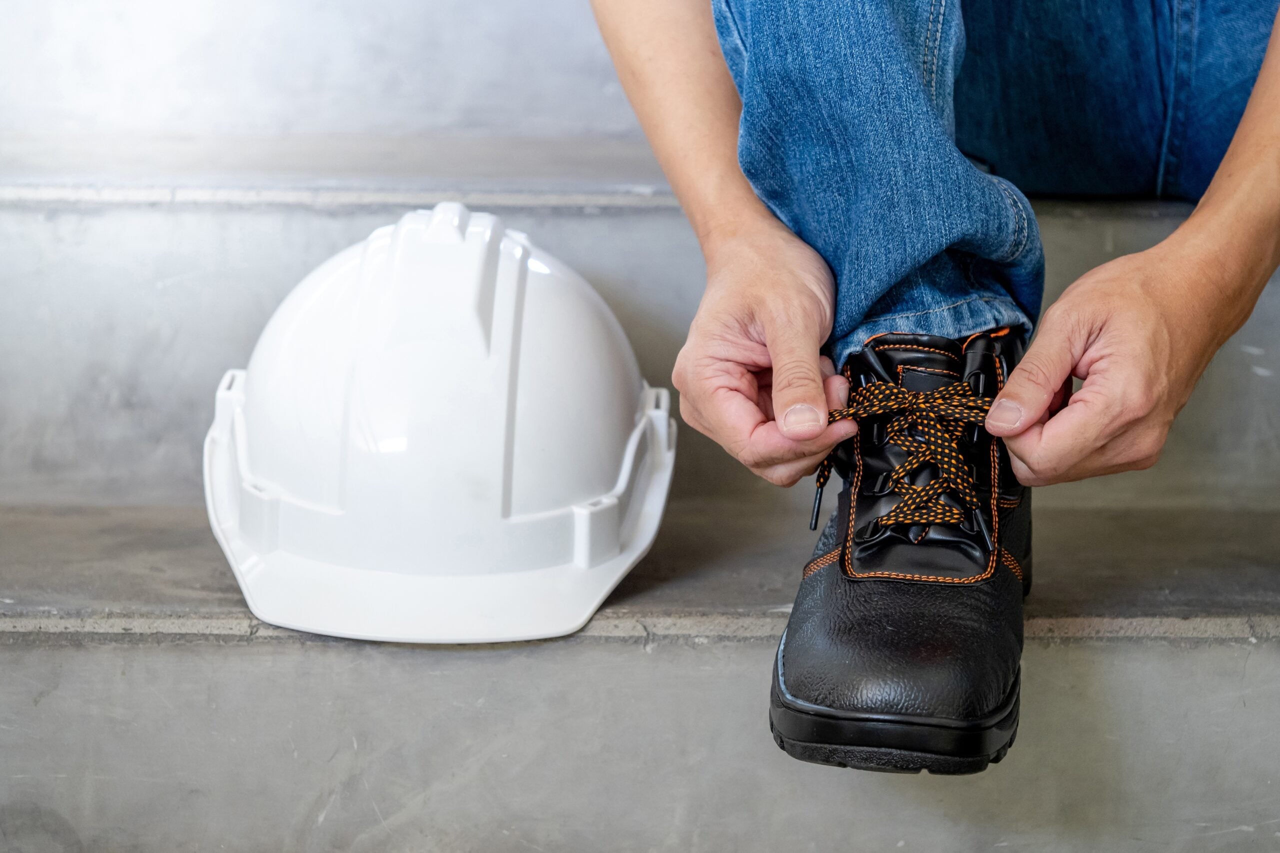 Man tying his work boots.