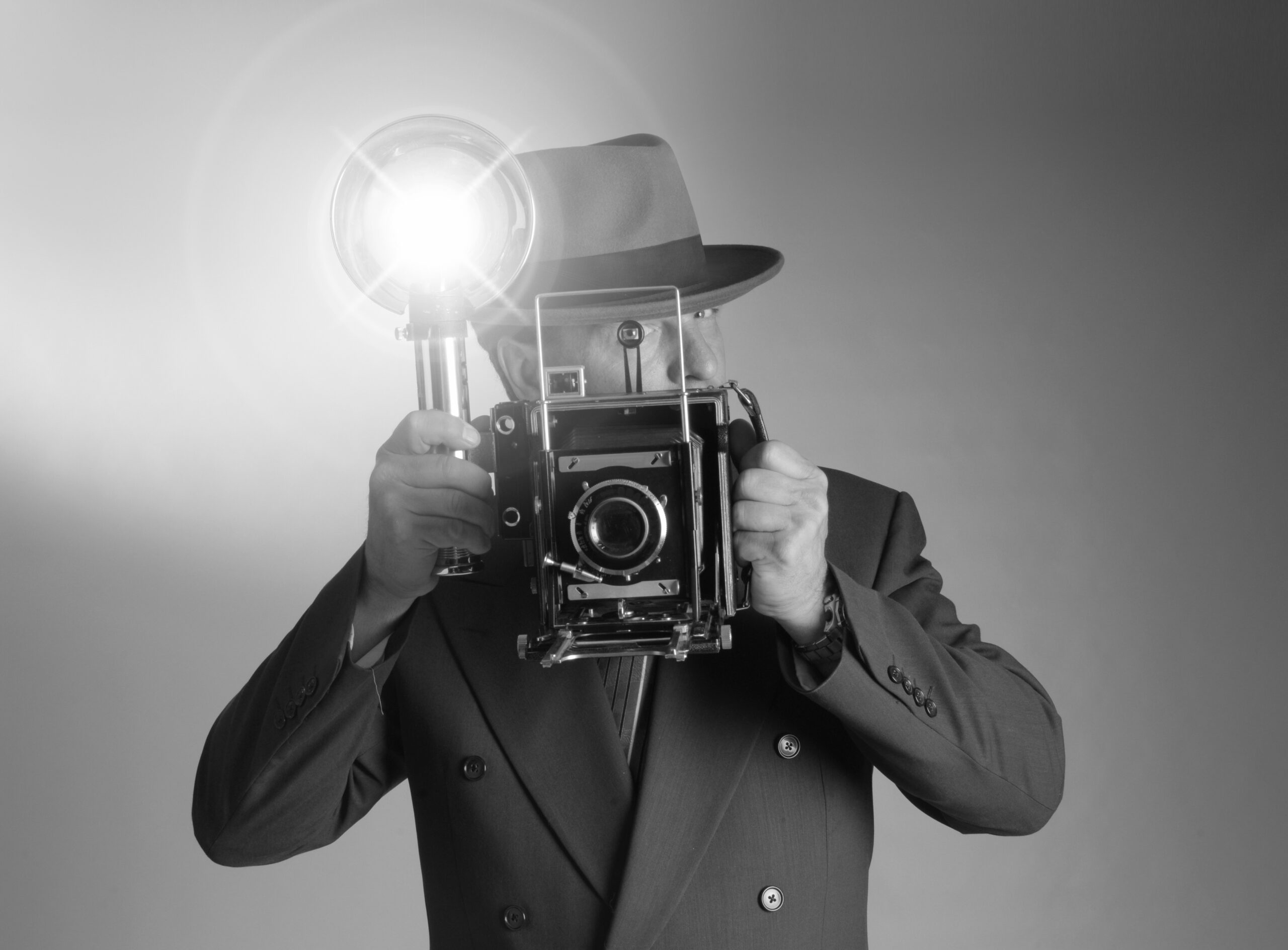 Photographer holding a vintage camera.