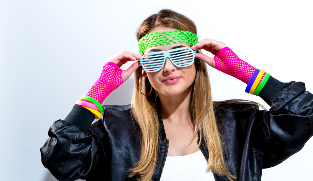 Woman in neon glasses and gloves.