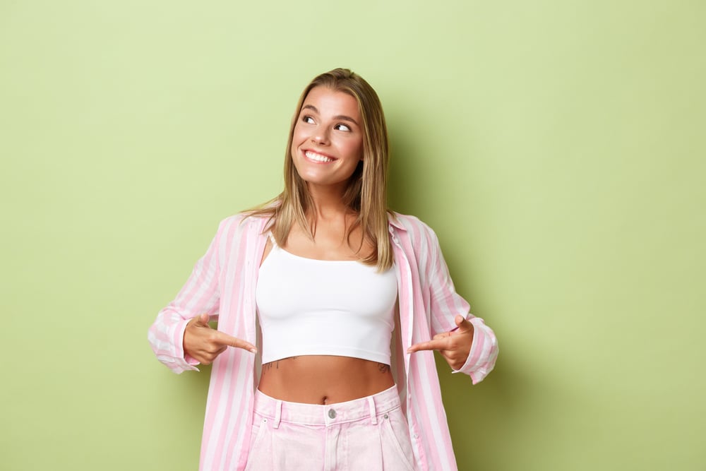 Woman pointing at her stomach.
