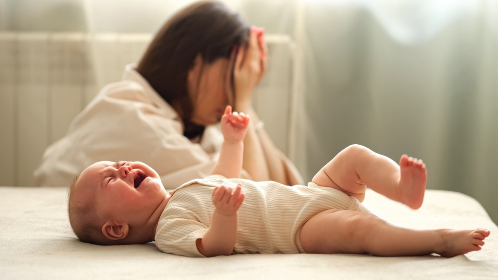 Exhausted new mom with infant.