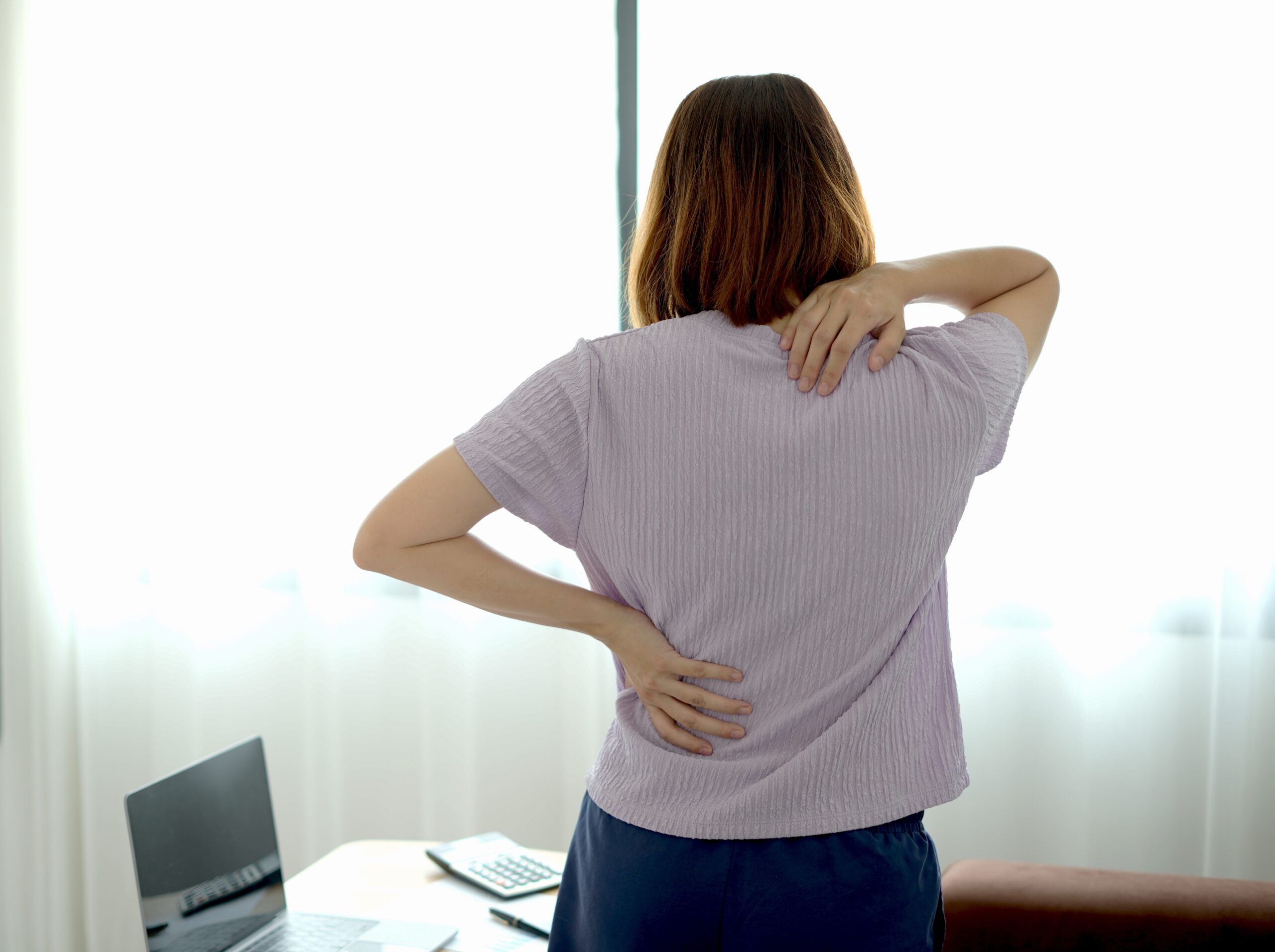 Woman who's back and shoulders are sore.