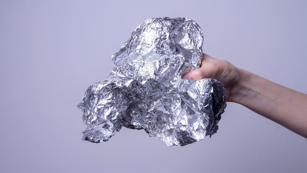 Woman holding aluminum foil.
