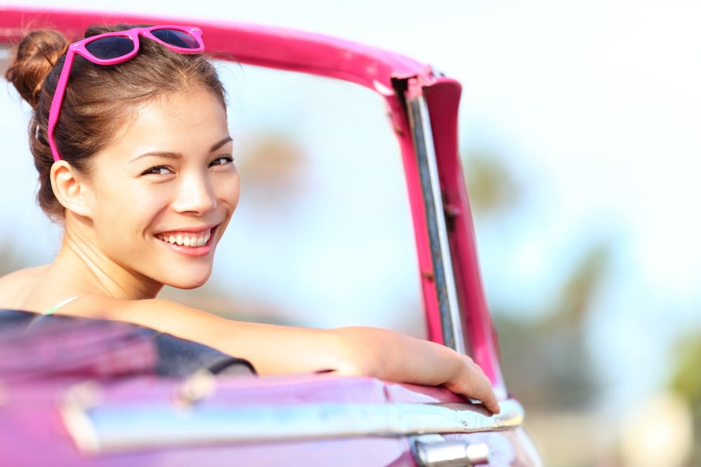 Woman smiling in her car.