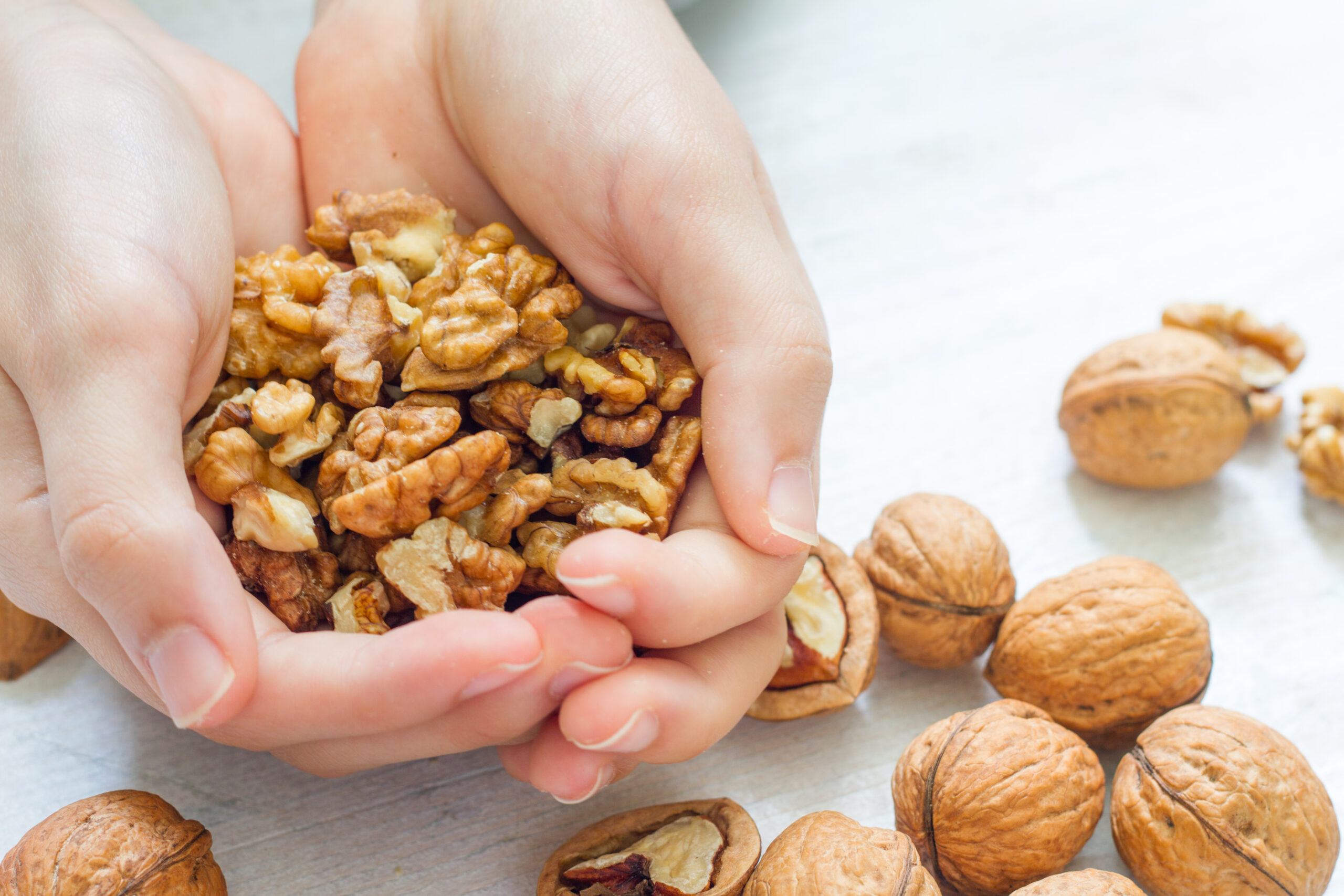Woman holding a handful of nuts.