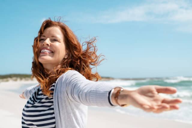 Woman smiling outside.