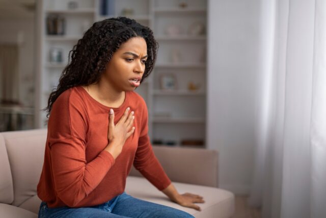 concerned woman holding her chest