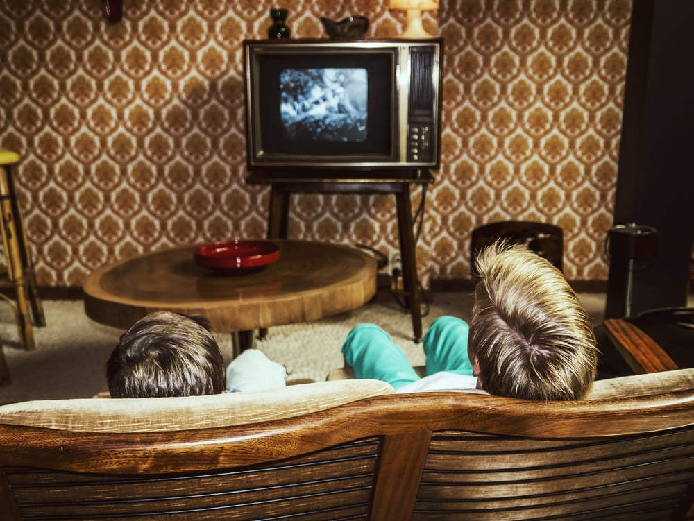 Two boys watching TV.
