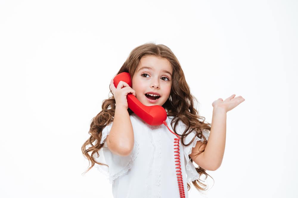 Little girl on a landline.